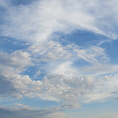Fluttering clouds against a crystal blue sky