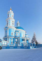 Famous beautiful old blue temple in honor of the Kazan Icon of the Mother of God in the classicism style 1816 in Siberian Telma village against of blue sky at cold winter day