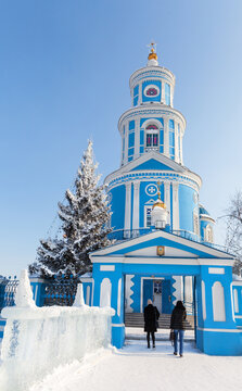 Beautiful blue bell tower of Orthodox Church in Telma village, Irkutsk region. Church in honor of Kazan Icon of Mother of God in the style of classicism 1816. Parishioners rush to the morning service
