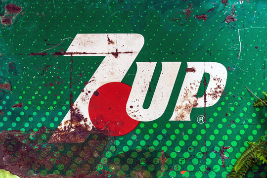 KANCHANABURI, THAILAND-DECEMBER 29,2019 : Close up vintage 7 UP logo banner, old rusty and broken zinc plate of 7 UP soft drink sign board advertising to decorate in retro style at coffee shop.