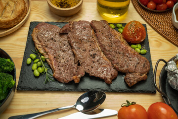 Kamui Wagyu Beef Strip Lloyd marble Steak Grill with fresh vegetaber salad, Baked Potatoes with butter