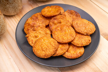 Japanese rice crackers or Senbei, Japan traditional snack, Senbei Japanese snack in black plate on wooden background
