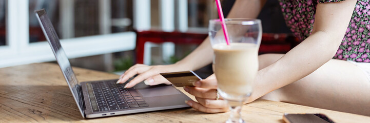 Pretty young asian business woman using laptop in modern cafe. Horizontal long banner for web design