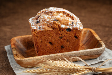 Fresh baked russian stolichny cake with raisins on brown background