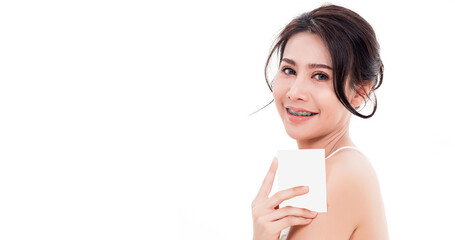 Asian young beautiful woman smiling she's holding blank square skin care near face for present product isolated on over white background, Beauty concept