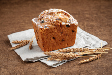 Fresh baked russian stolichny cake with raisins on brown background