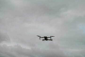 Fototapeta na wymiar Drone seen hovering in sky shot from low angle