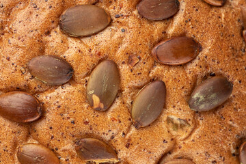 Closeup on pumpkin seeds bread texture background