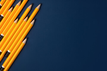 group of yellow pencil on navy blue table background