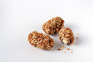 asian sweets candies with chocolate, nuts and cream on white background with copy space, selecive focus