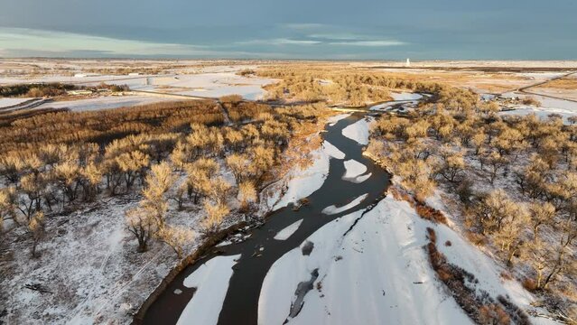 South Platte River flows in eastern Colorado plains and farmland near Milliken, aerial view of winter scenery