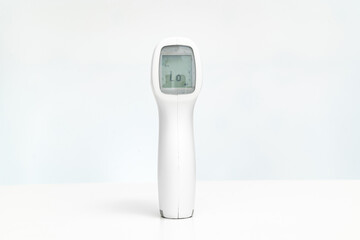 contactless electronic thermometer on a white background. measuring device for measuring body temperature. home medicine cabinet. sale of medical products for home use.