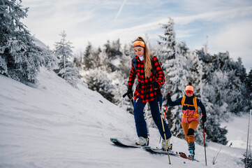 Mountaineer backcountry ski walking ski woman alpinist in the mountains. Ski touring in alpine...