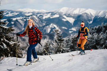 Mountaineer backcountry ski walking ski woman alpinist in the mountains. Ski touring in alpine...