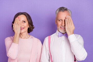 Portrait of two cheerful people arm palm covering eye look interested isolated on purple color background