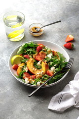 salad bowl with arugula, strawberry, cottage cheese, nectarine and peanut paste. healthy eating concept