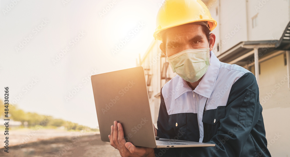Aufkleber closeup engineer hard hat using computer notebook for work in construction site