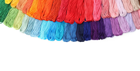 Set of colorful embroidery threads on white background, top view