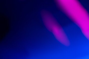 Neon light overlay. Defocused glow. Holographic illumination. Blur bright pink blue color UV radiance smooth texture on dark abstract copy space background.