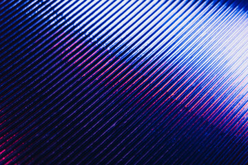 Holographic background. Ridged texture. Glowing grooved iron surface. Neon iridescent blue pink white color gradient light reflection on dark lines pattern abstract overlay.