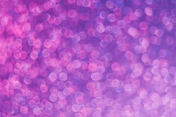 Ultraviolet abstract background. Bokeh glow. Blur shiny round sequin pattern. Defocused neon pink purple color light circles texture overlay.