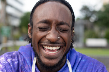 Portrait of young man laughing outdoors