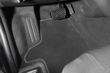 Grey soft floor carpet in car, closeup