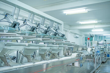 Fototapeta premium factory, industrial area, automation, technology, Machines for packing products Within the factory, sterile beauty industry in order to maintain maximum cleanliness.shallow focus effect. 