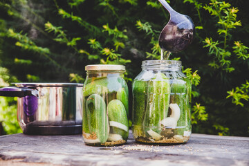 Making of homemade pickled cucumber with hot vinegar brew