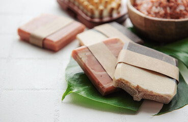 Handmade soap bars and green leaves