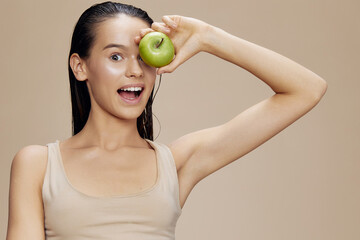 brunette green apple near face health isolated background