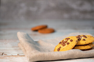 Homemade cookies with chocolate, nuts and coffee beans on a white background with a linen napkin with a background blur.