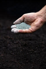 Man holding rock dust, flour or powders, minerals for the soil