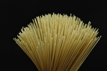 Dry spaghetti on a black background