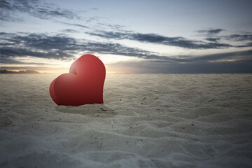 Heart on the sand with a dramatic sky background