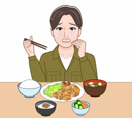 食事をしている若い男性