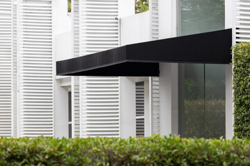 black awning over windows. canvas roof decoration of house.