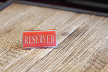 reserved sign on wooden table in restaurant.