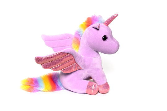 Unicorn plush toy sitting. Isolated on white background 