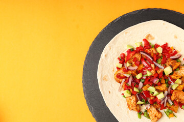Tasty taco on board on orange background