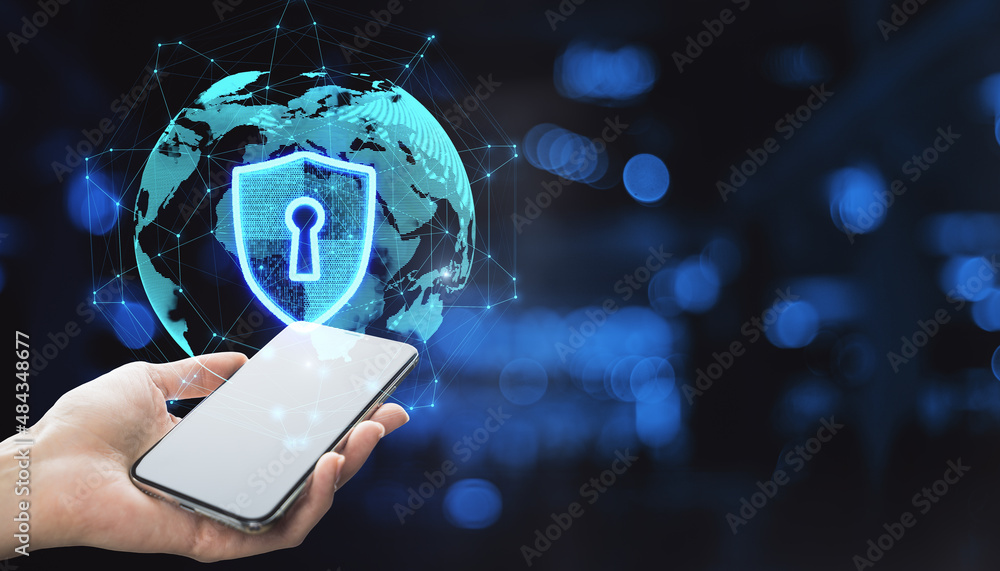 Poster Close up of hand holding smartphone device with abstract glowing globe hologram with security shield icon on blurry bokeh office interior background. Protection, data and technology concept. 