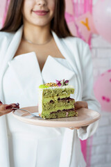 Beautiful woman celebrating birthday party holding a piece of cake making wish