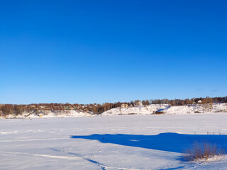 Fototapeta na wymiar Rural Russian winter landscape with Volga river and Tutaev village