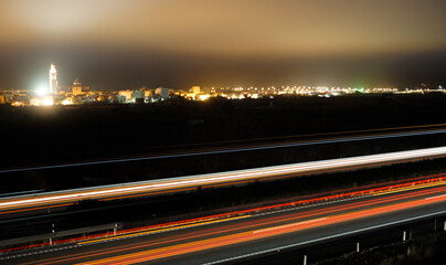 Fototapeta na wymiar Traffic light streaks formed by cars driving along the freeway.