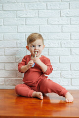 A small child learns to brush his teeth with a toothbrush. Dental hygiene in children