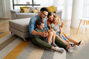 Device technology family online education concept. Happy family with digital devices at home.