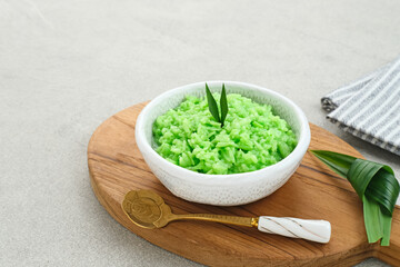 Tape Ketan Pandan is a typical Indonesian food made from fermented sticky rice. Served in small bowl. Selected focus.
