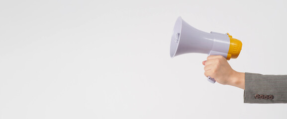 Hand is hold megaphone and wear grey suit on white background.