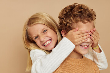 Little boy and girl gesticulate with their hands together Lifestyle unaltered
