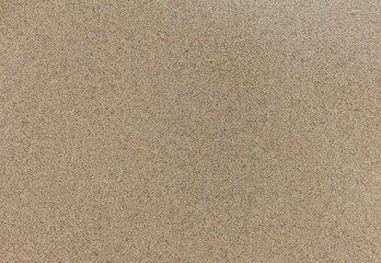 Fototapeta na wymiar Smooth sand background. Natural sand texture. Sandy beach surface, top view.